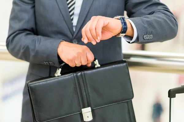 Businessman looking at wrist watch