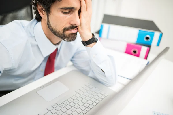 Stressed businessman looking at computer