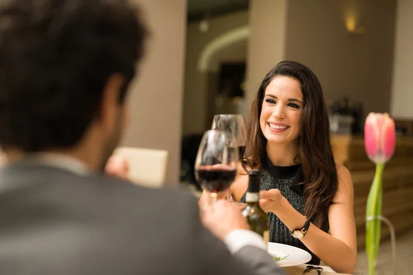 Couple toasting wineglasses in restaurant