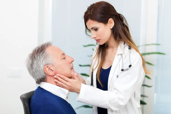 Doctor checking lymph nodes size of patient