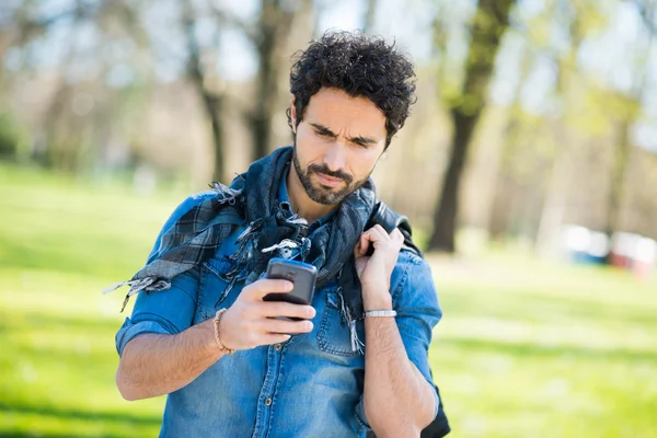 Man walking while looking at phone