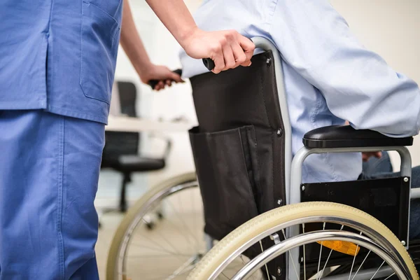 Nurse taking care of patient on wheelchair