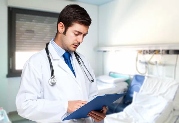 Doctor reading document in hospital