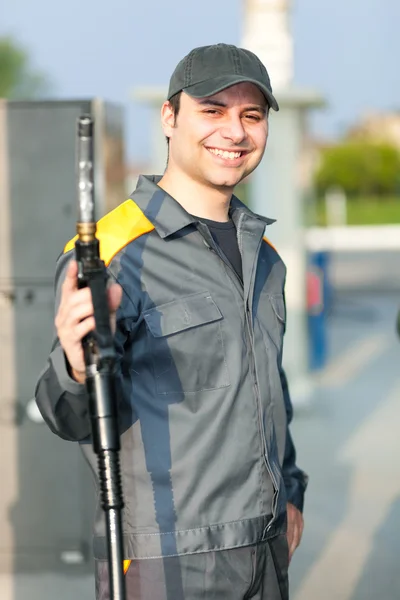 Smiling worker at gas station
