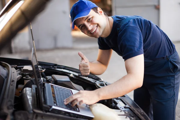 Mechanic using laptop computer