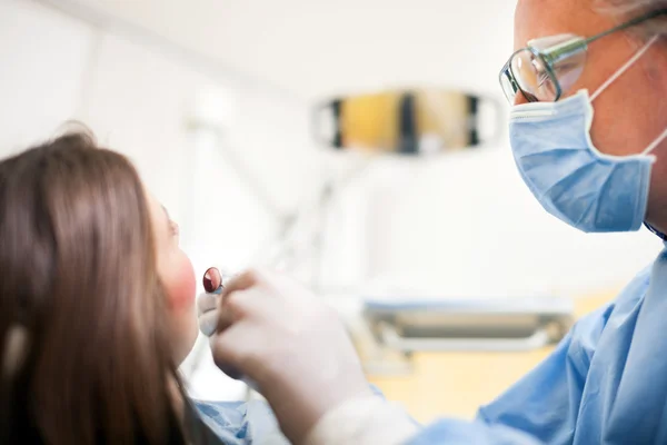 Dentist doing dental treatment on patient