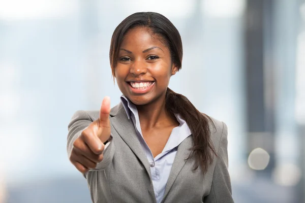 Business woman giving thumbs up