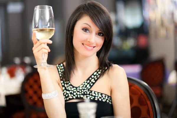 Woman tasting wine in restaurant