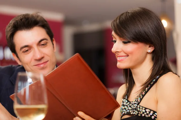 Couple reading menu in restaurant