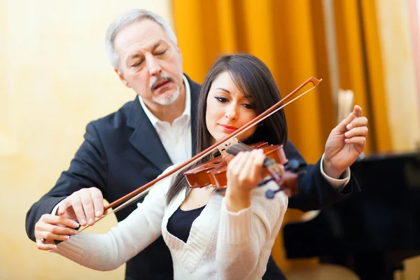 Violin teacher with student