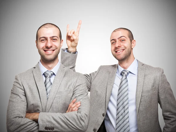 Businessman making horns