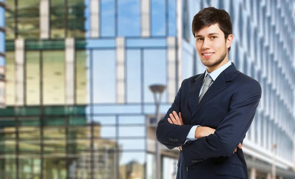 Young businessman with folded arms