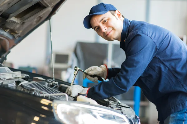 Auto mechanic at work on car