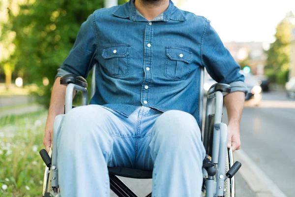 Man using a wheelchair in an urban street