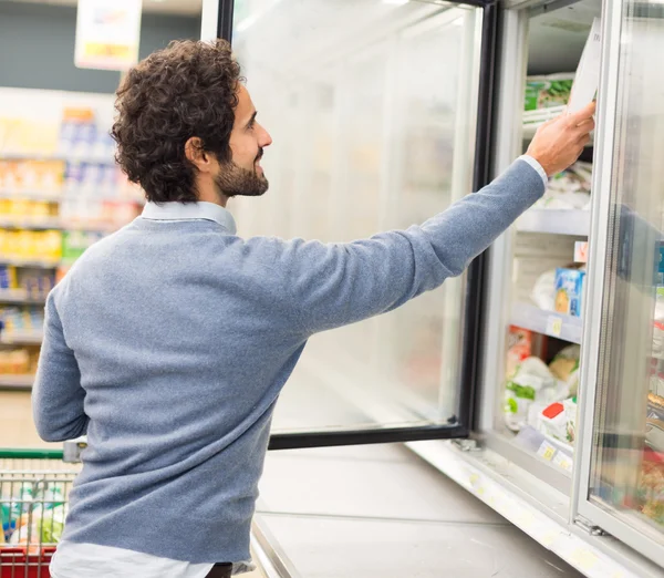 Man taking deep frozen food from freezer