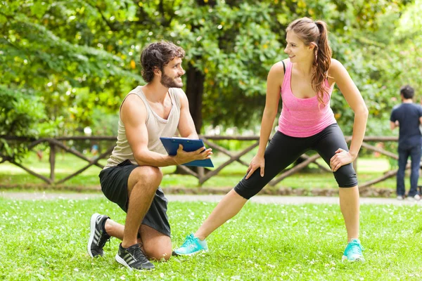 Man showing training program to woman