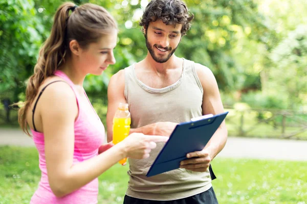 Couple reading training program in park