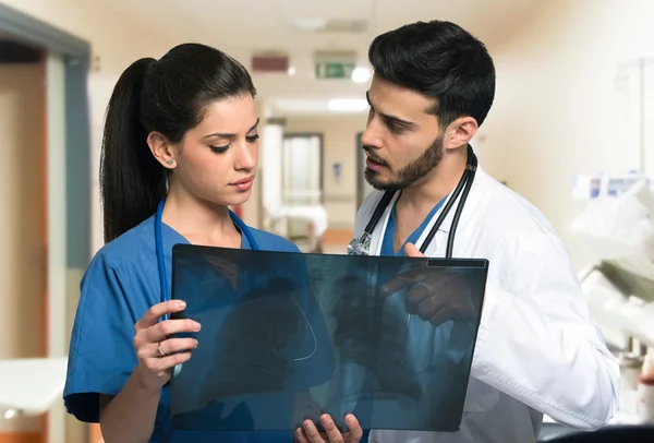 Medical workers looking at a radiography