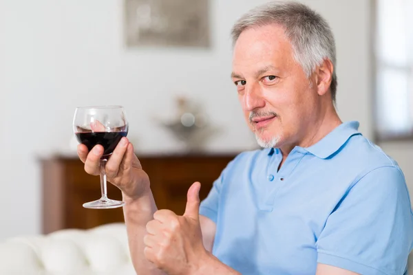 Man drinking glass of wine