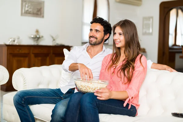 Smiling couple watching tv