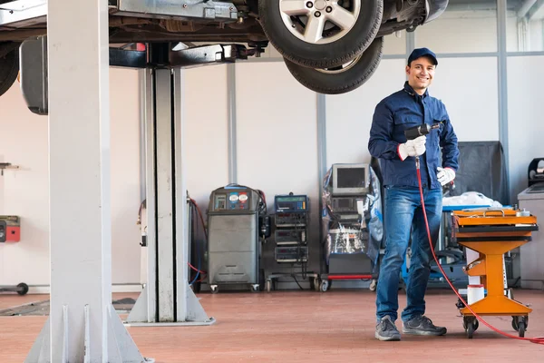 Mechanic repairing car in garage