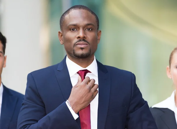 Businessman adjusting his necktie