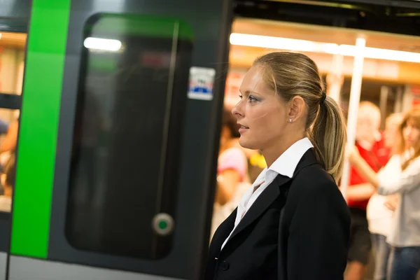Businesswoman coming out from subway train