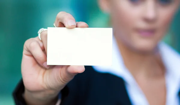 Business woman holding blank card