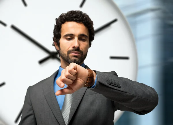 Businessman looking at watch