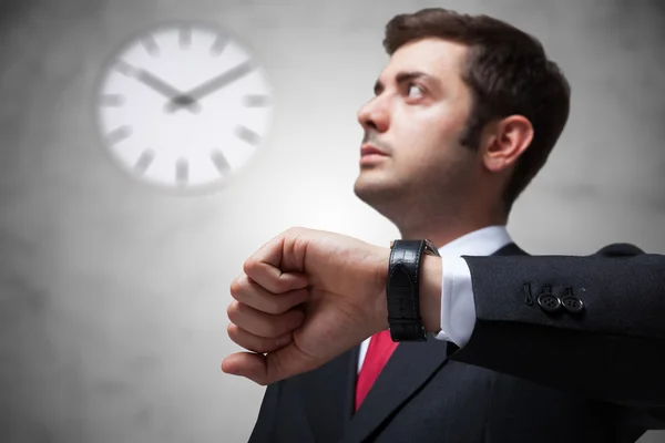 Businessman looking at watch