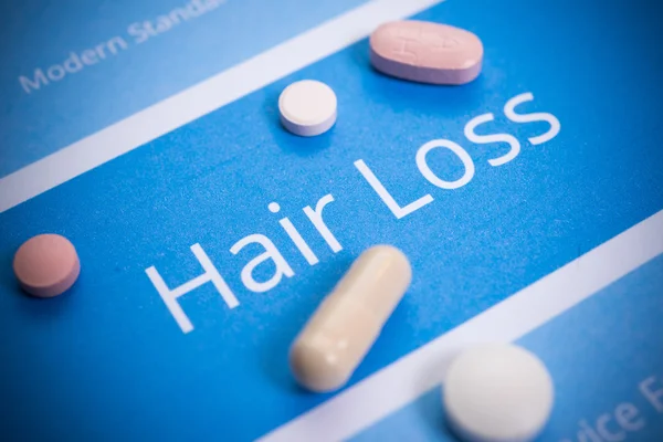 Hair loss concept with different pills