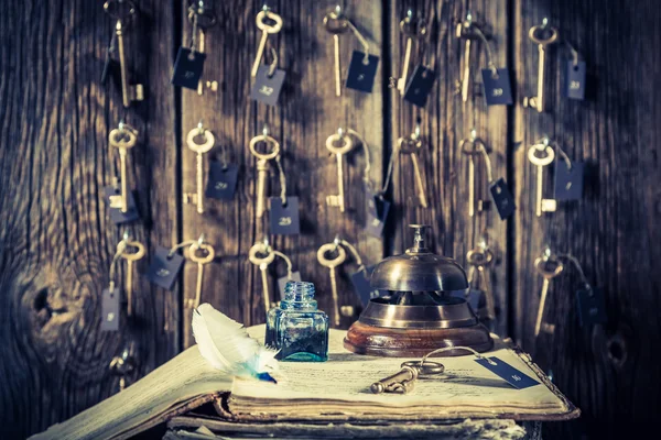 Vintage front desk in hotel with keys for rooms and guestbook