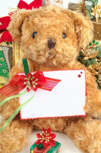 Christmas teddy bear with gifts and white space card