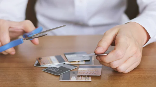 Cutting credit card with scissors