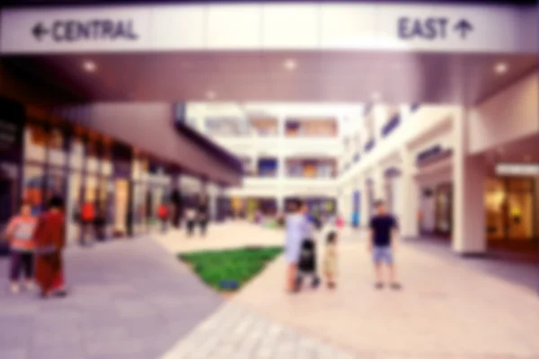 Blurred image of people in shopping mall , vintage filter