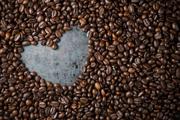 Heart in coffee beans on metal background