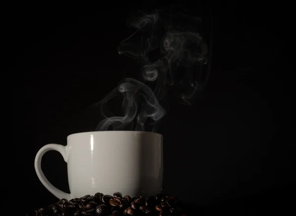 Cup of smoke and coffee beans