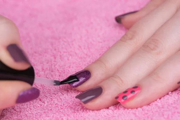 Feminine nails with pink and purple polish