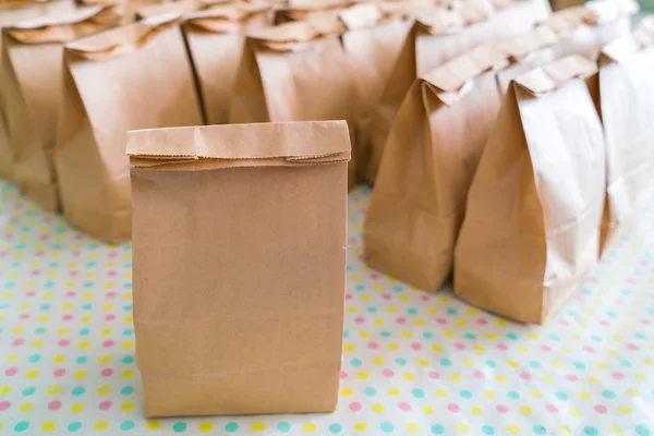Brown paper bags on table .