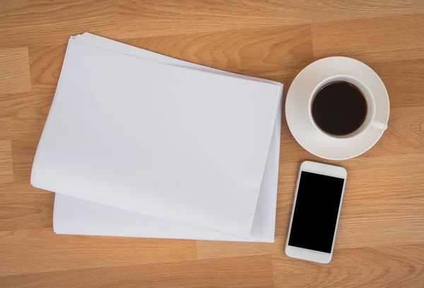 Papers with coffee cup and mobile phone