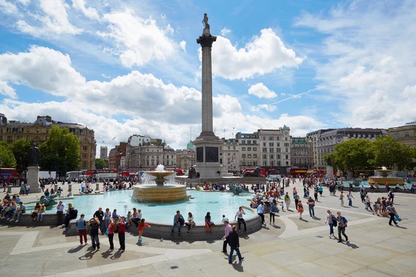 Trafalgar square in a sunny day, with people and tourists