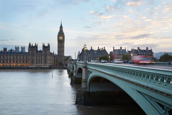 Big Ben and Palace of Westminster, traffic on bridge at dusk in London