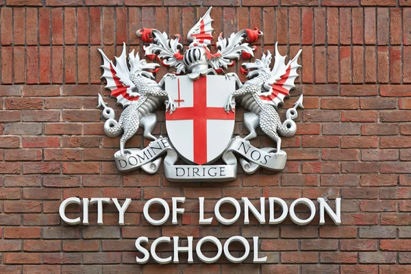 City of London school sign on red bricks wall in London, UK