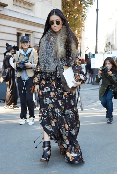 Woman poses for photographers before Chloe show, Paris fashion week