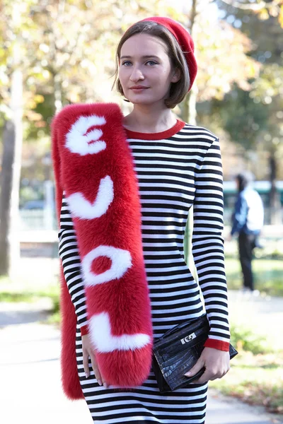 Woman with love red scarf poses for photographers, Paris fashion week