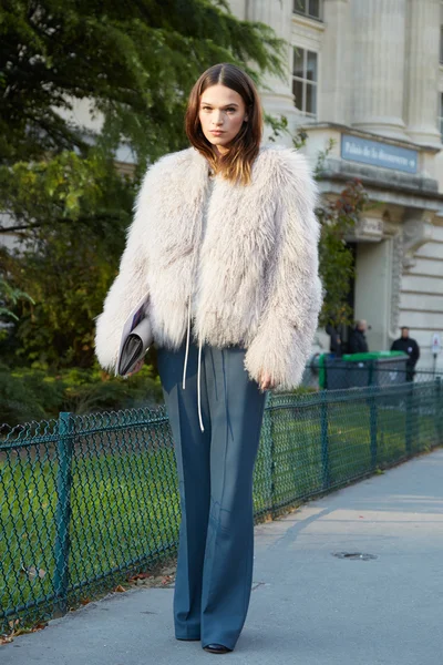 Woman poses for photographers before Chloe show, Paris fashion week