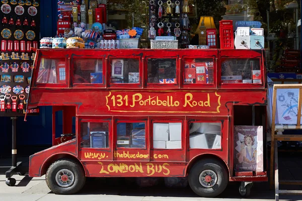 Portobello road souvenir shop with red bus model in London