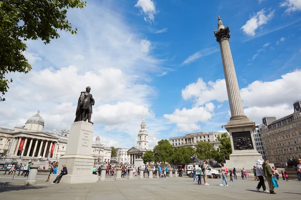 Trafalgar square in a sunny day, people and tourists in London