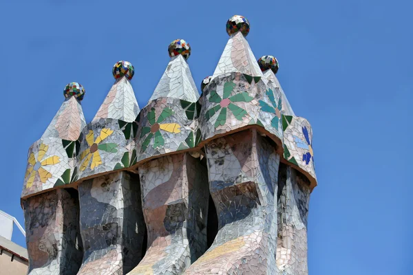 BARCELONA - AUGUST 13, 2007: The famous architect Gaudi treated rooftop chimneys like pieces of art on the rooftop of the house Casa Batllo on Barcelona, Spain