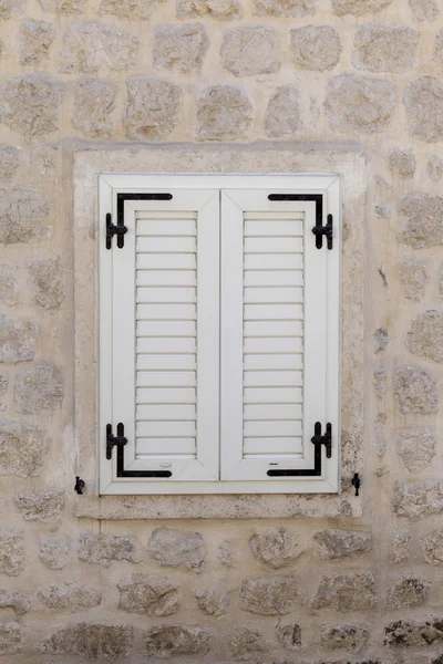 Wooden window, stone house